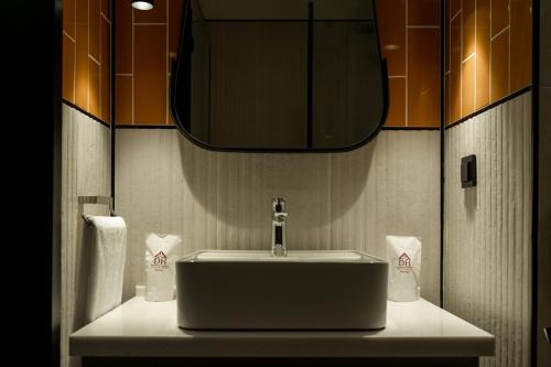 un bagno con lavandino e specchio di Dostyk Business Hotel ad Aqtau