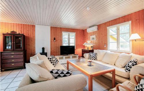 a living room with two couches and a table at 3 Bedroom Gorgeous Home In Aakirkeby in Vester Sømarken