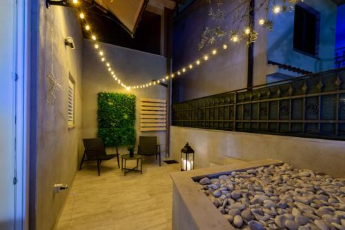 a courtyard with a rock garden with lights at Studio Apartment Mare with private garden and jacuzzi in Vinkuran