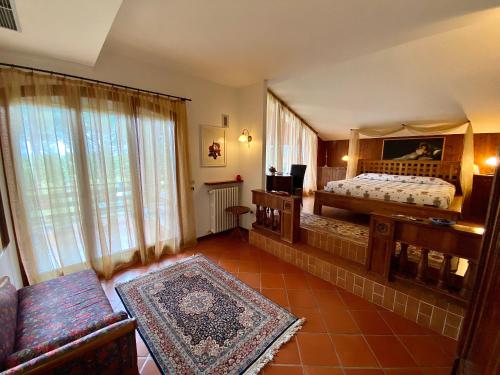 a bedroom with a bed and a couch in a room at Casale del fattore in Cesena