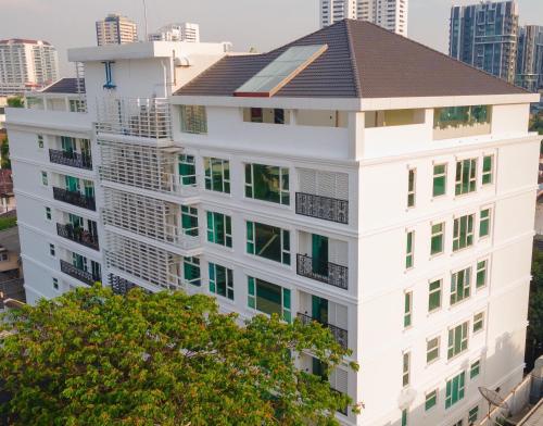 a white building with a roof on top of it at GM Residence in Bangkok