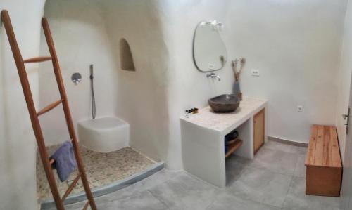 a bathroom with a sink and a mirror at Volcan Secret Cave in Karterados