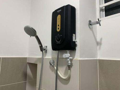 a soap dispenser on a wall in a bathroom at Ssrhomestay/S2/Corner lot/15pax in Seremban