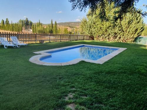 a swimming pool in the middle of a yard at Chalet Las Praderas in Chillarón de Cuenca