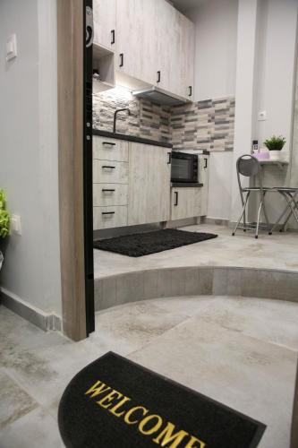a kitchen with a black welcome mat on the floor at MSK Rotonda Studio 2 in Thessaloniki