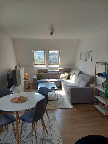a living room with a couch and a table at Apartment 075 in Tuzla