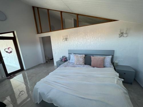 - une chambre avec un grand lit et des oreillers dans l'établissement Immanuel Villa, à Ptghni