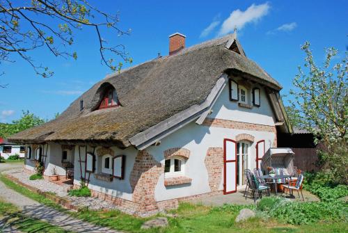 ein kleines Haus mit einem Strohdach in der Unterkunft Ferienhaus unterm Reetdach in Ostseebad Sellin