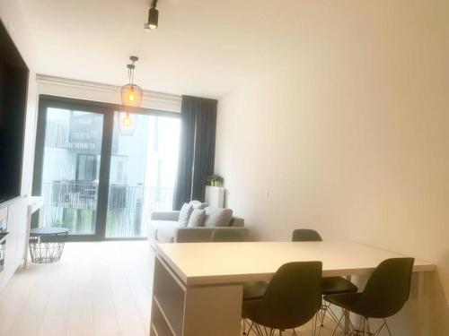 a living room with a couch and a table and chairs at Appartement au Centre Ville in Brussels