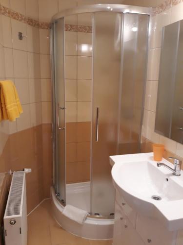 a bathroom with a shower and a sink at Privát JOZEF in Vrbov