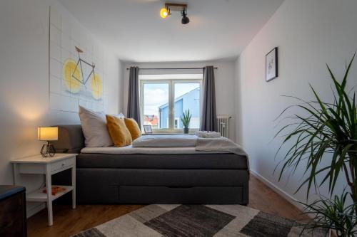 a bedroom with a bed and a window at J & K Apartments Kelheim in Kelheim