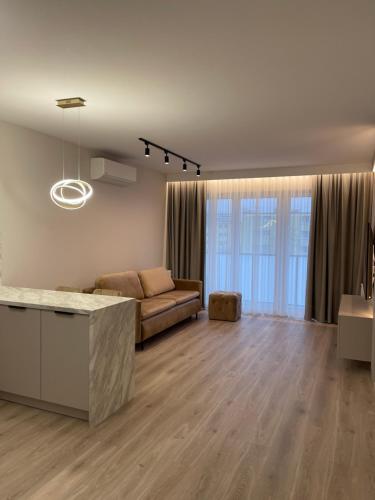a living room with a couch and a table at Moris Boutique Beach Hotel in Gdańsk