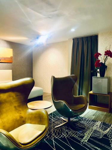 a living room with two chairs and a table at Sri Langit Hotel KLIA, KLIA 2 & F1 in Sepang