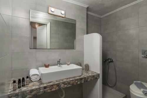 y baño con lavabo, espejo y aseo. en Fani Dream Suite en Pachaina