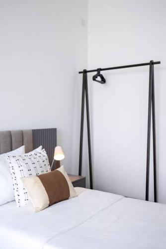 a bedroom with a white bed with a spotlight on it at Twin Peaks residence in Colombo