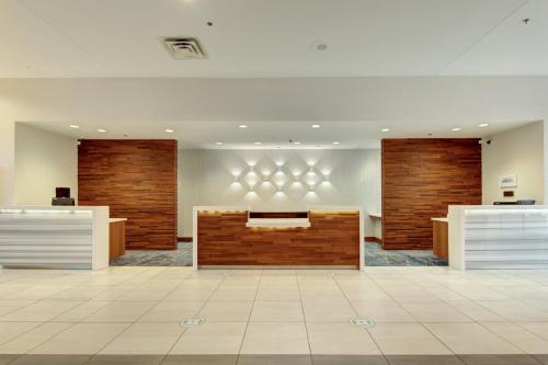 a lobby with a reception desk in a building at Tulsa Marriott Southern Hills in Tulsa