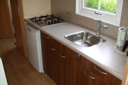 a kitchen with a sink and a stove at Camping de Watertoren in Landgraaf
