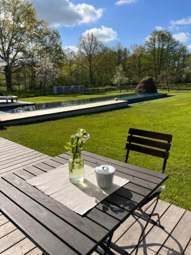 a picnic table with a vase of flowers on it at NaturApartments - Hideaway & Spa in Burg