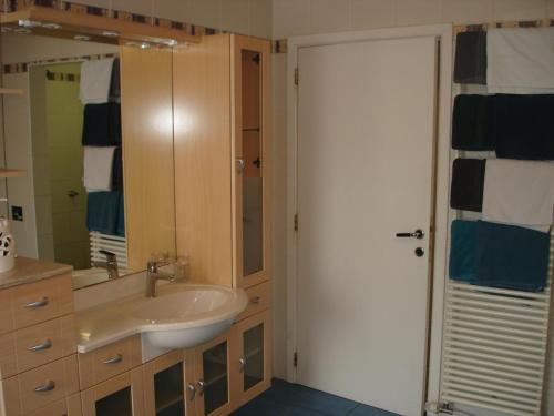 a bathroom with a sink and a mirror at appartement Courcelles in Courcelles