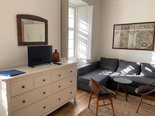a living room with a couch and a dresser at Apt. overlooking the castle Nižbor20km from Prague in Nižbor