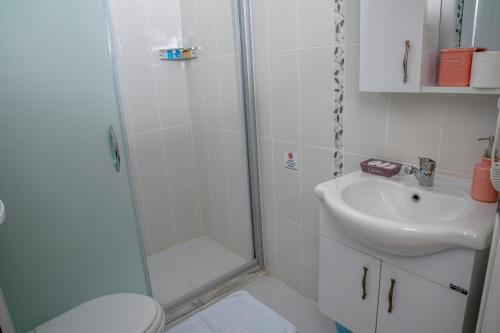 a bathroom with a shower and a sink at Goknar Knidos Nature Hotel and Farm in Datca