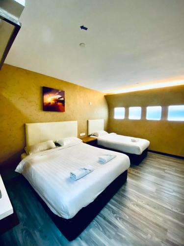 a hotel room with two beds in a room at Sri Langit Hotel KLIA, KLIA 2 & F1 in Sepang