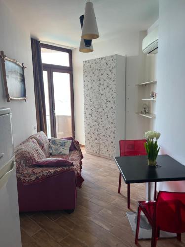 a living room with a couch and a table at L'angolo di Filo in Teulada