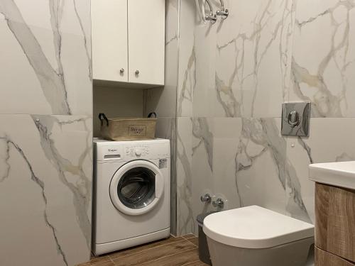 a bathroom with a washing machine and a toilet at Michael's House - Argostoli in Argostoli