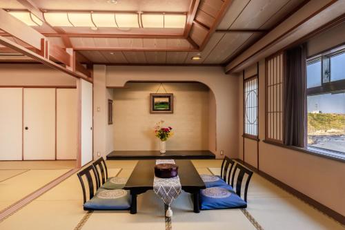 a dining room with a table and chairs at 銚子グランドホテル in Choshi