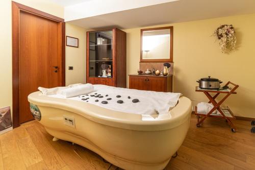 a large bath tub sitting in a room at Lux Garden Hotel in Azuga