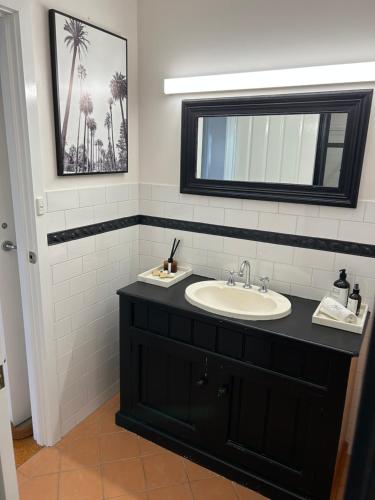 a bathroom with a sink and a mirror at Kiana Beach House in Port Lincoln