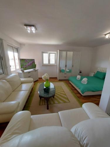 a living room with a couch and a table at Apartment Andric 2 in Trebinje
