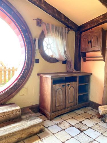 a kitchen with wooden cabinets and a window at Едем in Brzezhany
