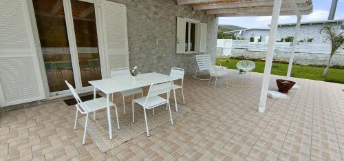 a white table and chairs on a patio at Janus Casa nel Verde - Relax Pool & Spa in Giano Vetusto