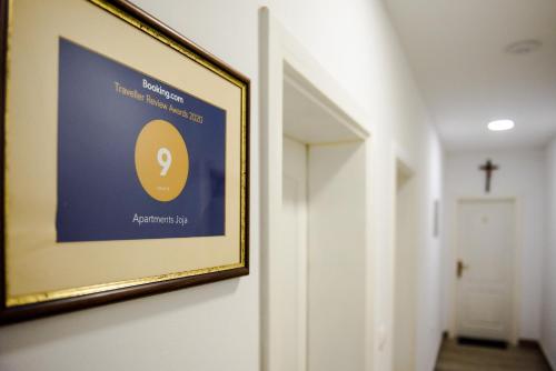 a picture hanging on a wall in a hallway at Apartments Joja in Međugorje