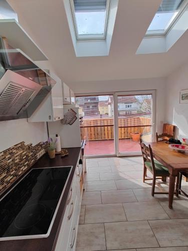 a kitchen with a table and a dining room at Ferienwohnung Biene in Saarbrücken