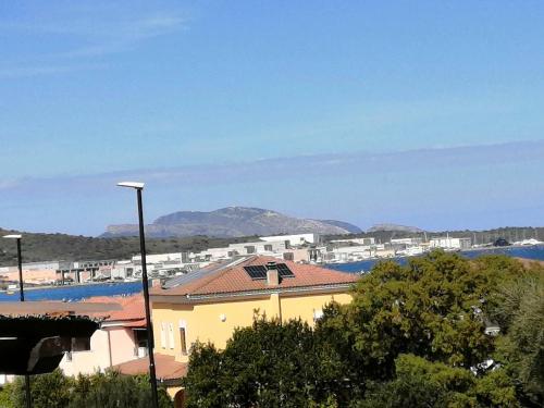 a yellow building with a view of a city at Il Nido in Olbia