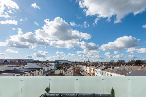 a view of a city with buildings and clouds at The Burton Penthouse by Fortuna Property Portfolio in Cheltenham