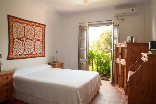 a bedroom with a bed and a large window at Cerro de Hijar in Tolox