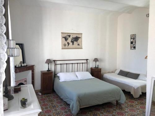1 dormitorio con 2 camas y 2 mesitas de noche en AUX GOUTS D'ANGELENE en Molières-sur-Cèze