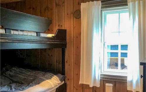 a bedroom with a bed and a window in a room at Awesome Home In Geilo With Sauna in Skoro