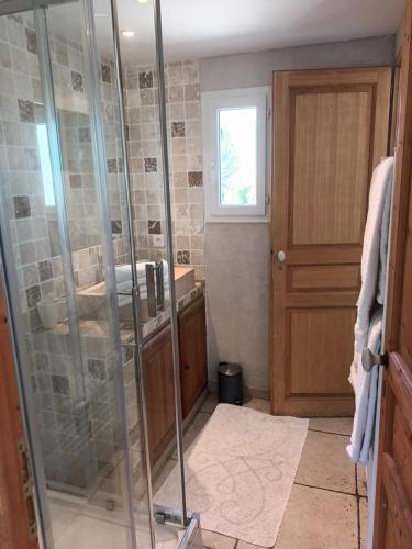 a bathroom with a shower with a glass door at Le Mas des Genets in Saint-Rémy-de-Provence