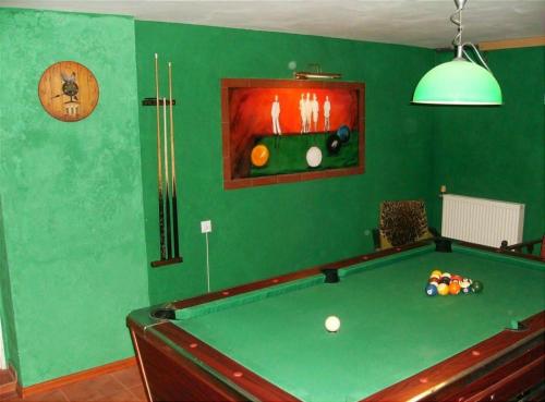 a green room with a pool table in it at Domek Aga in Węgorzewo