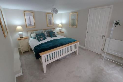 um quarto com uma cama grande e um cobertor verde em The Den, 2 mins Chelt High Street, John Lewis etc em Cheltenham