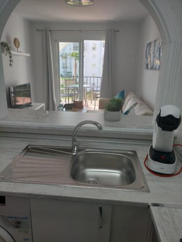 a kitchen counter with a sink and a window at Apartamentos Laguna Beach 2 in Torrox Costa