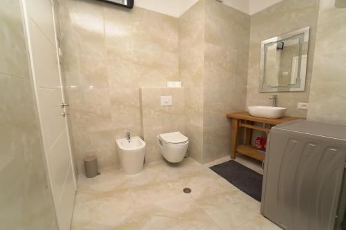 a bathroom with a toilet and a sink at Beachfront Marilyn in Durrës