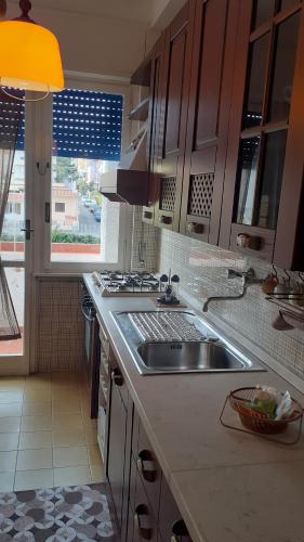 a kitchen with a sink and a stove at Central Station House in Santa Marinella