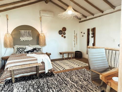a bedroom with a bed and a chair at CASA MUNDI in Caraíva