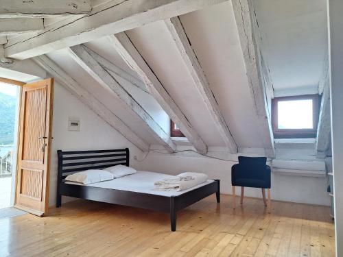 a bedroom with a bed and a chair in a room at Forteca home in Perast