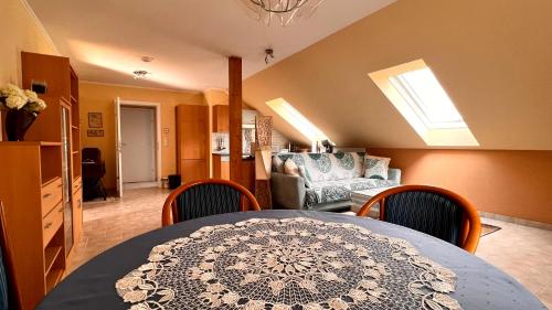 a dining room with a table and chairs and a couch at Ferienwohnung Brenner in Bruck an der Mur